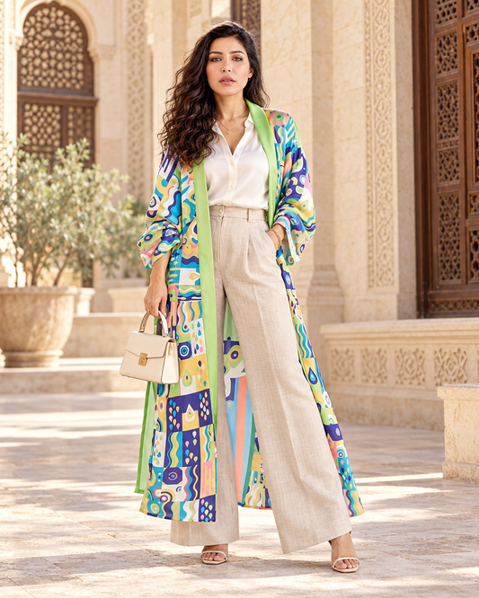 Macaw Magic long cardigan in multicolor abstract print with lime trim, worn with linen trousers
