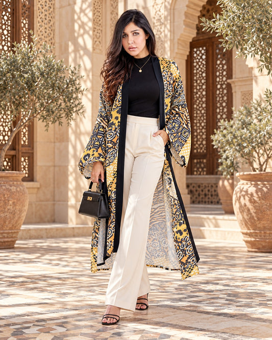 Wildcat long cardigan in yellow and navy animal print with black trim, worn with ivory trousers and a black top